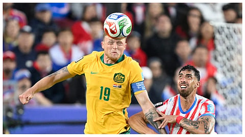 Australia's Harry Souttar (19) battles for the ball with Paraguay's Gabriel Avalos (21) during the World Cup Group D soccer match between Paraguay and Australia
in Santa Clara